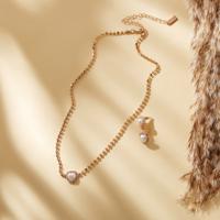 Stone Studded Necklace with Heart Shaped Pearl Pendant and Earrings